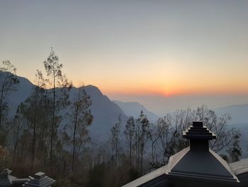 Scenic view of snowcapped mountains against sky during sunset