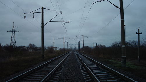 Empty railroad tracks against sky