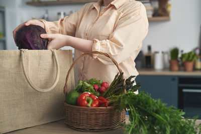 Midsection of woman holding wicker basket