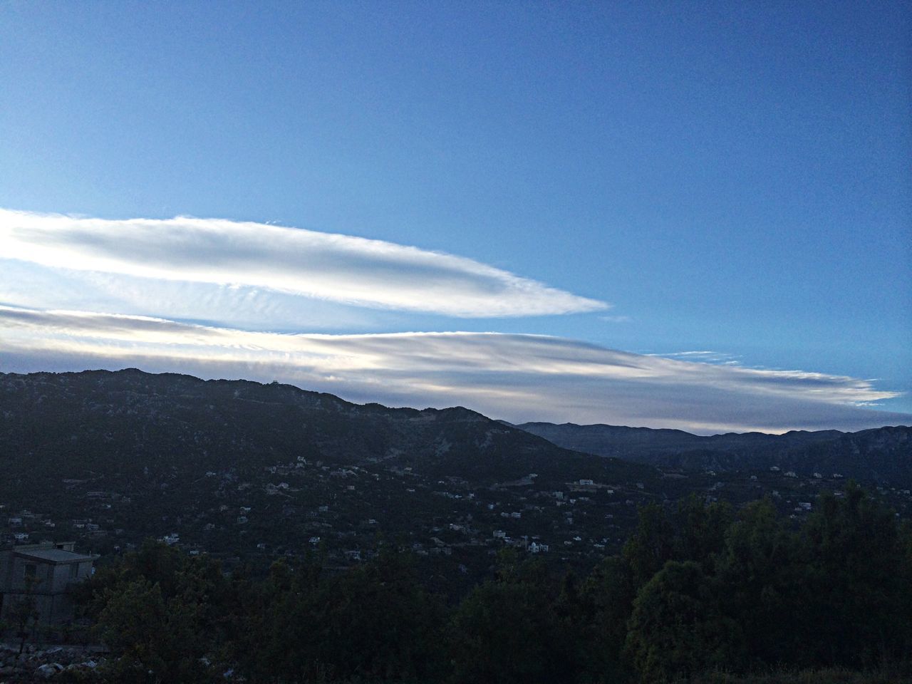 mountain, blue, sky, mountain range, landscape, scenics, beauty in nature, tranquil scene, building exterior, nature, tranquility, built structure, tree, copy space, architecture, cloud - sky, high angle view, cloud, outdoors, no people