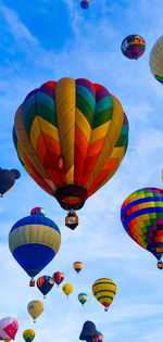 Low angle view of hot air balloons flying in sky