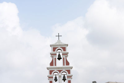 Low angle view of bell tower against sky