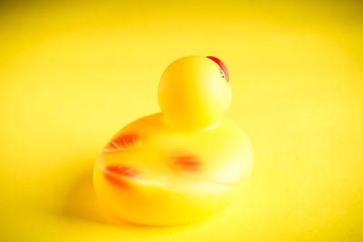 Close-up of yellow tomato against orange background