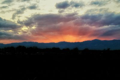 Scenic view of mountains against sky at sunset