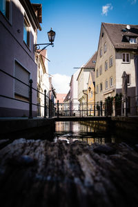 View of canal by buildings in city