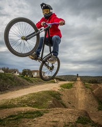 Low angle view of man jumping while doing bmx cycling