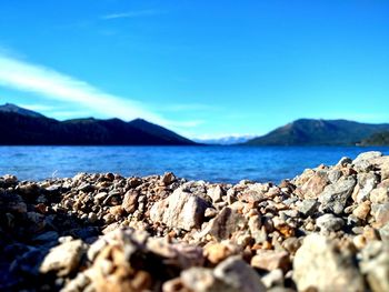 Rocky shore against blue sky