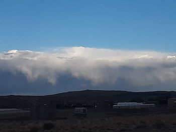 Houses on mountain against sky