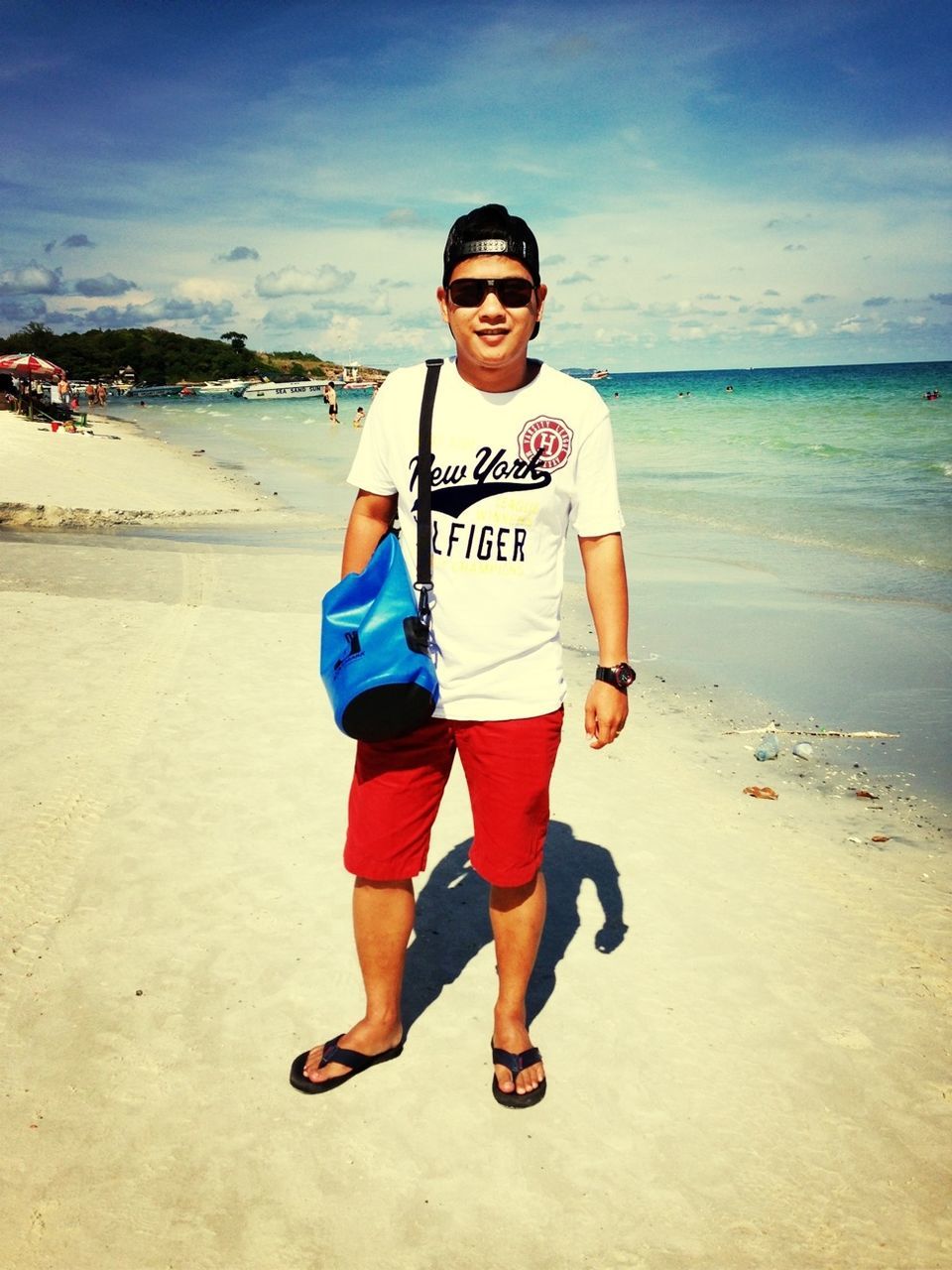 beach, sea, person, casual clothing, lifestyles, looking at camera, portrait, shore, sand, water, leisure activity, front view, full length, sky, sunglasses, standing, vacations, young men