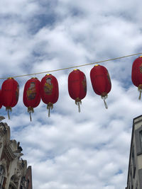 Low angle view of lanterns hanging against sky