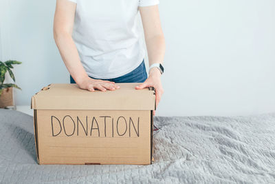 Midsection of woman holding gift on snow