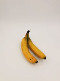 High angle view of yellow fruit against white background