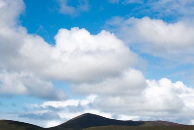 Scenic view of mountains against cloudy sky