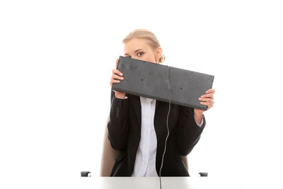 Portrait of woman standing against white background