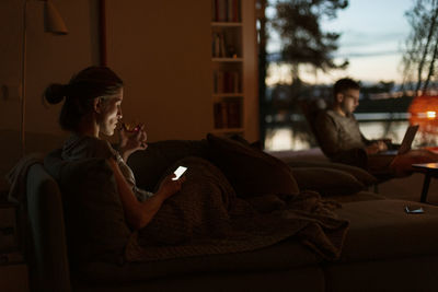 Woman at home using cell phone