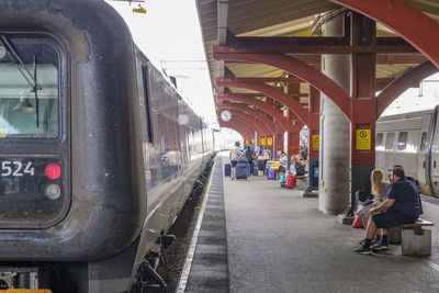 People waiting at railroad station platform