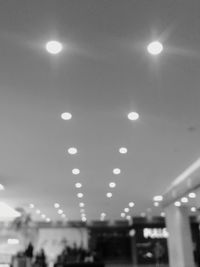 Low angle view of illuminated lamp at night