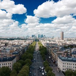 View of cityscape against cloudy sky