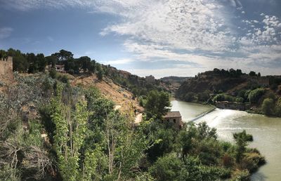 High angle view of river amidst trees against sky