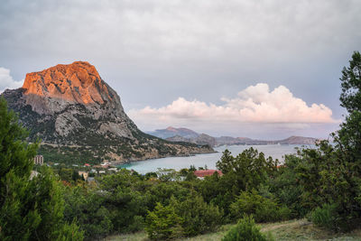 Aerial panoramic view of mount falcon lit by novyi svit. sudak, the republic of crimea