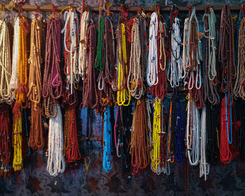 Full frame shot of multi colored prayer beads hanging at market stall