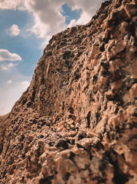 Low angle view of rock formation against sky