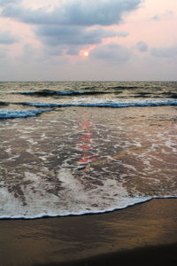 Scenic view of sea against cloudy sky