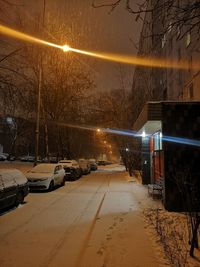 Cars on street in city during winter at night