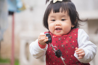 Portrait of cute girl playing outdoors