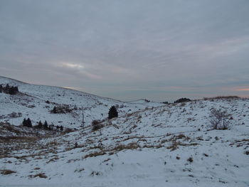 Scenic view of snow covered mountains against sky