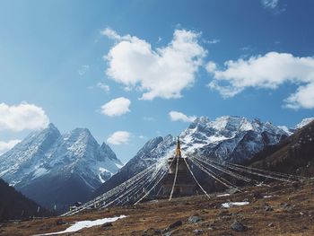 Shrine by mountains against sky