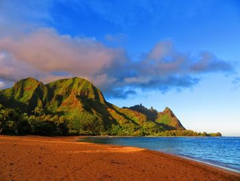 Scenic view of sea and mountains against sky