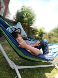 Boy relaxing in hammock at yard