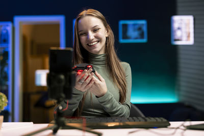 Young woman using mobile phone at table