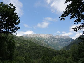 Scenic view of mountains against cloudy sky