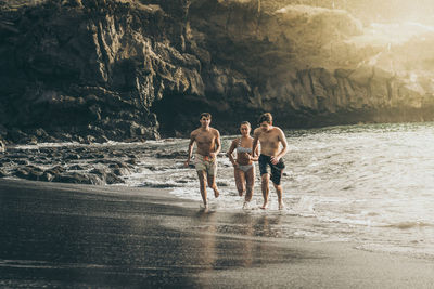 Friends running at beach