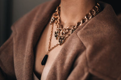 Gold chain hanging on a woman's neck. beautiful elegant luxury jewelry accessories