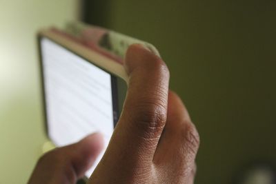 Close-up of hand using mobile phone