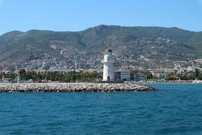 Lighthouse on building by sea