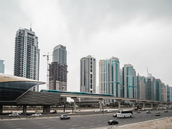 View of city street and buildings against sky