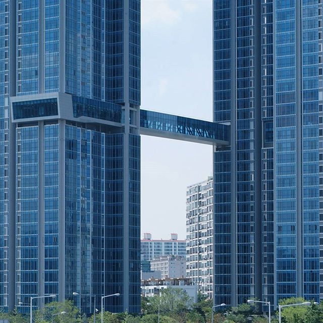 building exterior, architecture, built structure, city, modern, office building, skyscraper, low angle view, building, tall - high, tower, glass - material, city life, sky, day, window, financial district, outdoors, tall, reflection