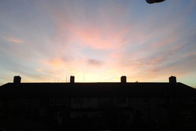 Low angle view of building against sky at sunset