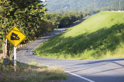 Road sign by trees