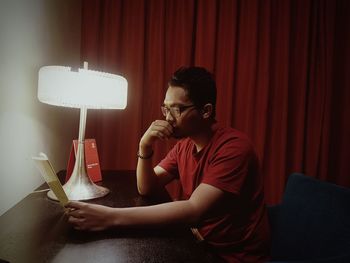 Man reading card at table