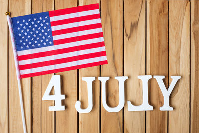 Close-up of flag against wooden wall