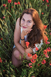 Portrait of a smiling young woman lying down on land