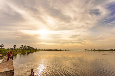 Scenic view of lake against sky during sunset