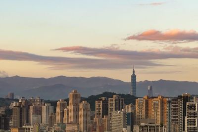 View of buildings against cloudy sky during sunset