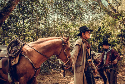 Men and horse in forest