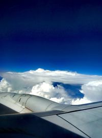 Aerial view of clouds over mountains seen from airplane